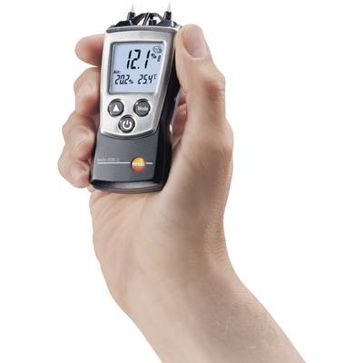 A handheld device for displaying air quality is being held. The screen shows '12.1% Air 20°C 25%'.