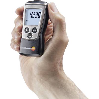 A hand is holding a digital tachometer displaying '4230' revolutions per minute. The device has a black body and a silver control panel.