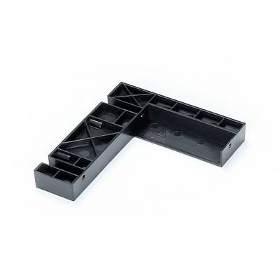Black, L-shaped plastic component with multiple compartments and reinforcing struts, likely for assembly or construction purposes.
