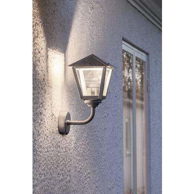 Outside light on a white wall, illuminated, beside a window.