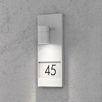 House wall with a modern wall light and the house number '45'.