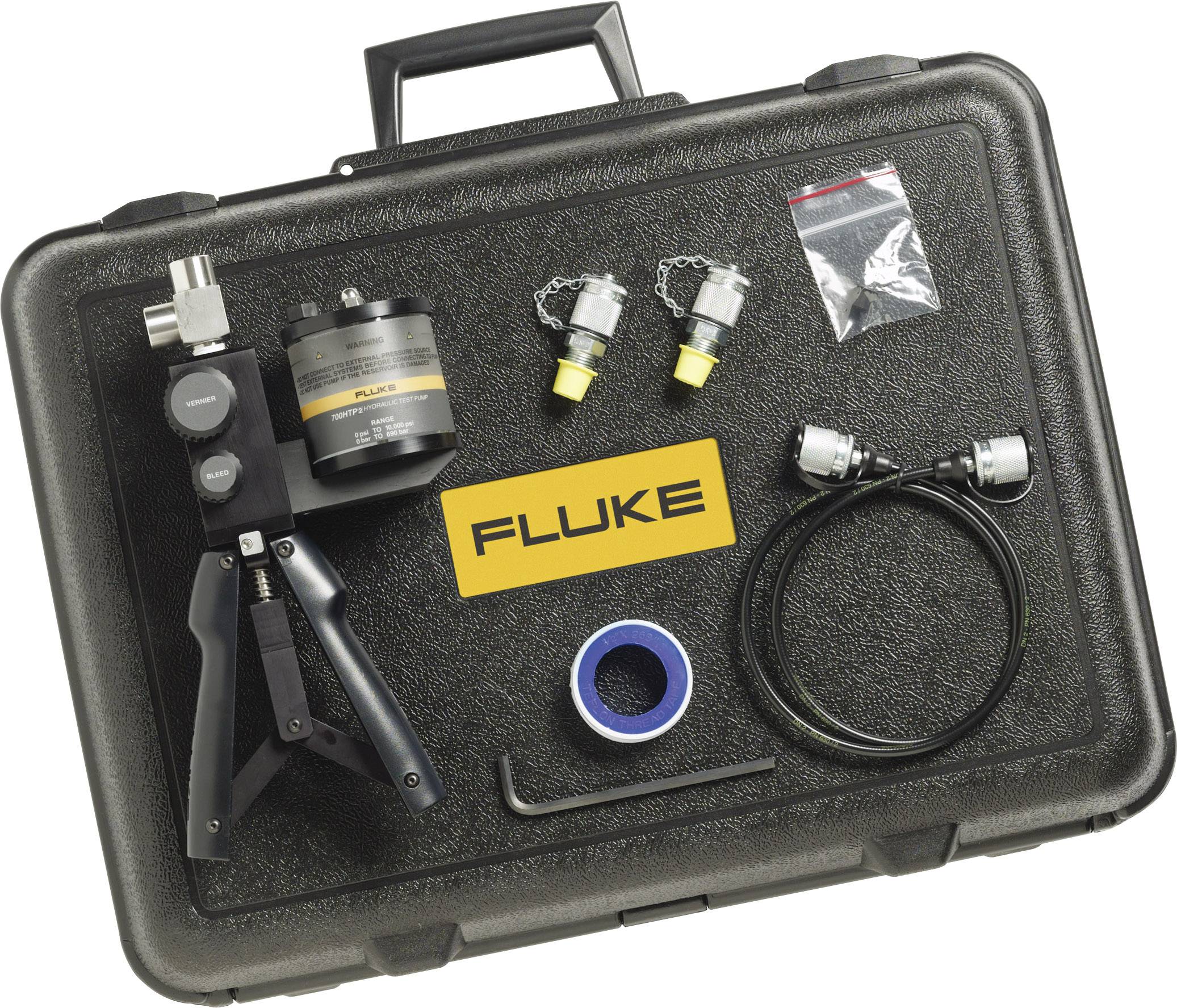 A black case containing tools for measuring instruments. Included are a device with handles, a round device, two adapters, a cable, adhesive tape, and a yellow 'Fluke' logo.