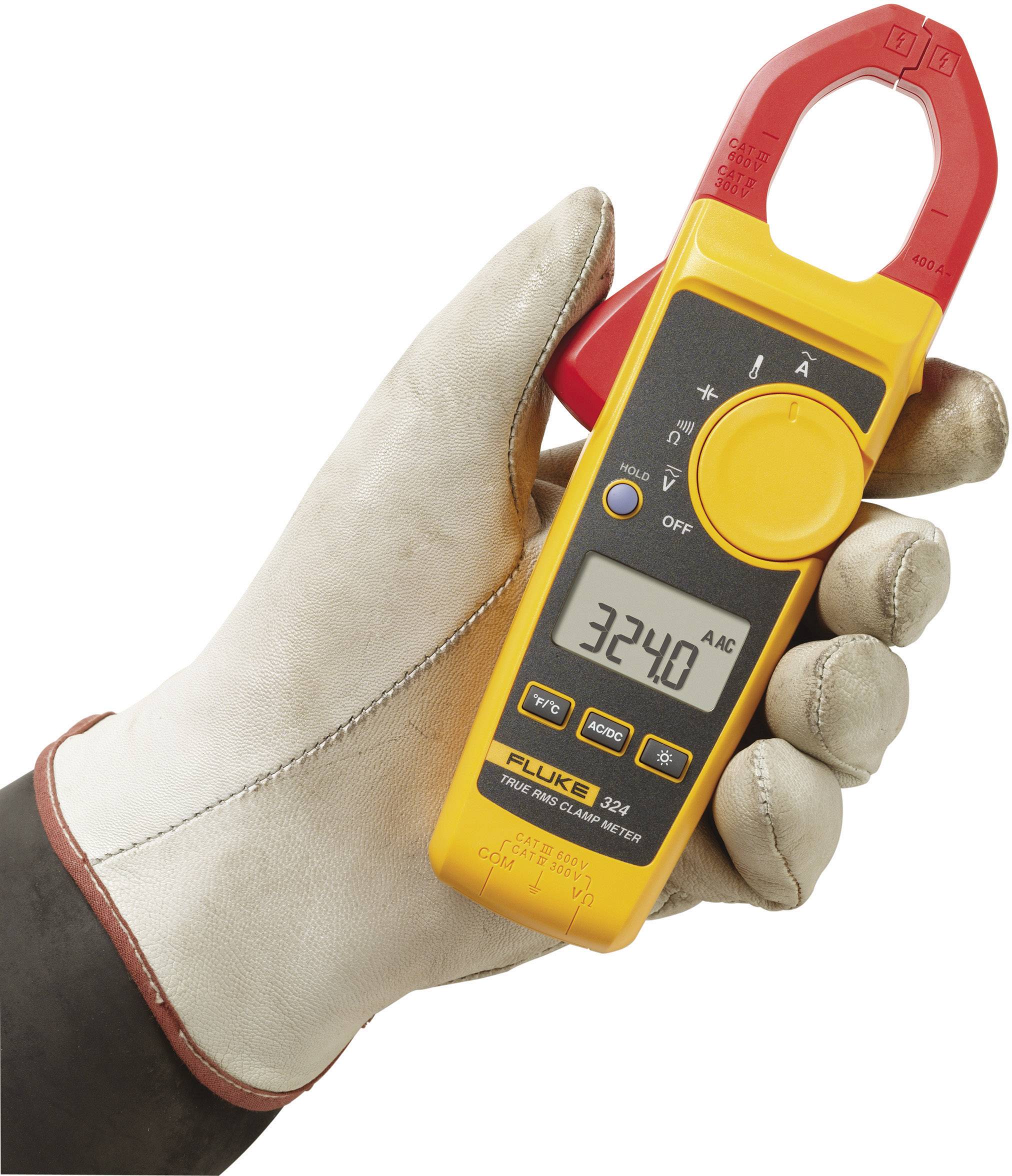 A gloved hand holds a clamp multimeter displaying '3240 AAC'. The device is used for measuring alternating current.