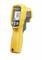 A yellow infrared thermometer displays a temperature of 62.0 degrees. It has a black handle and buttons for operation.