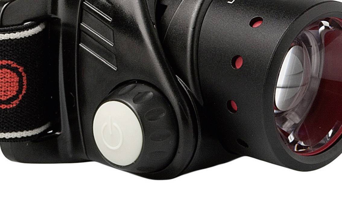 Headtorch with a black casing, red reflector, and white on/off switch.