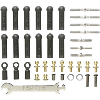 A set of black plastic connecting rods, golden screws, nuts, and a TAMIYA key are neatly arranged.