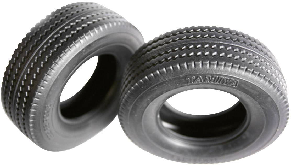 Two black model tyres with different tread patterns, standing side by side.