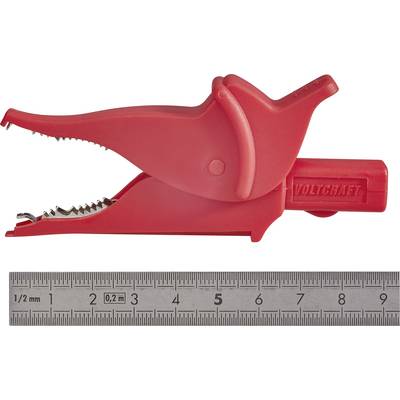 Red crocodile clip with serrated jaws, opened; with a ruler alongside for size comparison.