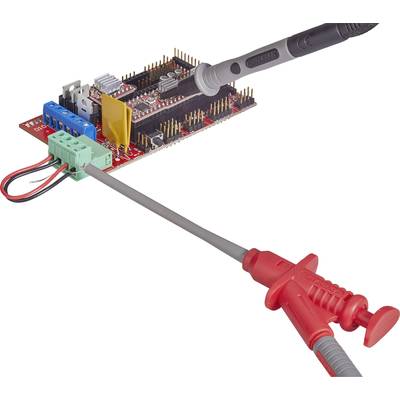 Electronic circuit board with connected control cable and testing device, indicating signal connection and measurement.