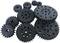 Several black cogwheels of different sizes lie on a white surface.