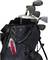 A golf bag with several golf clubs and a red penknife attached to the side.