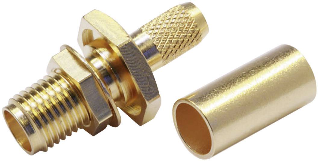A gold-coloured coaxial plug with a removable sleeve, commonly used in communication devices, lies on a white surface.