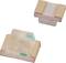 Two tiny, rectangular electronic components with flat metal contacts, possibly SMD LEDs, on a white background.