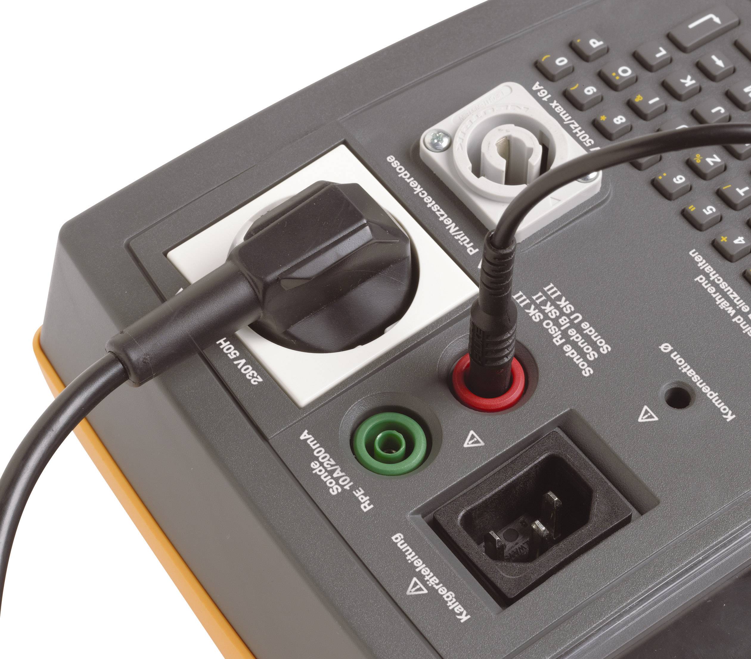 A measuring device in close-up view, featuring multiple ports, including power connection and sockets for various measurement cable types.