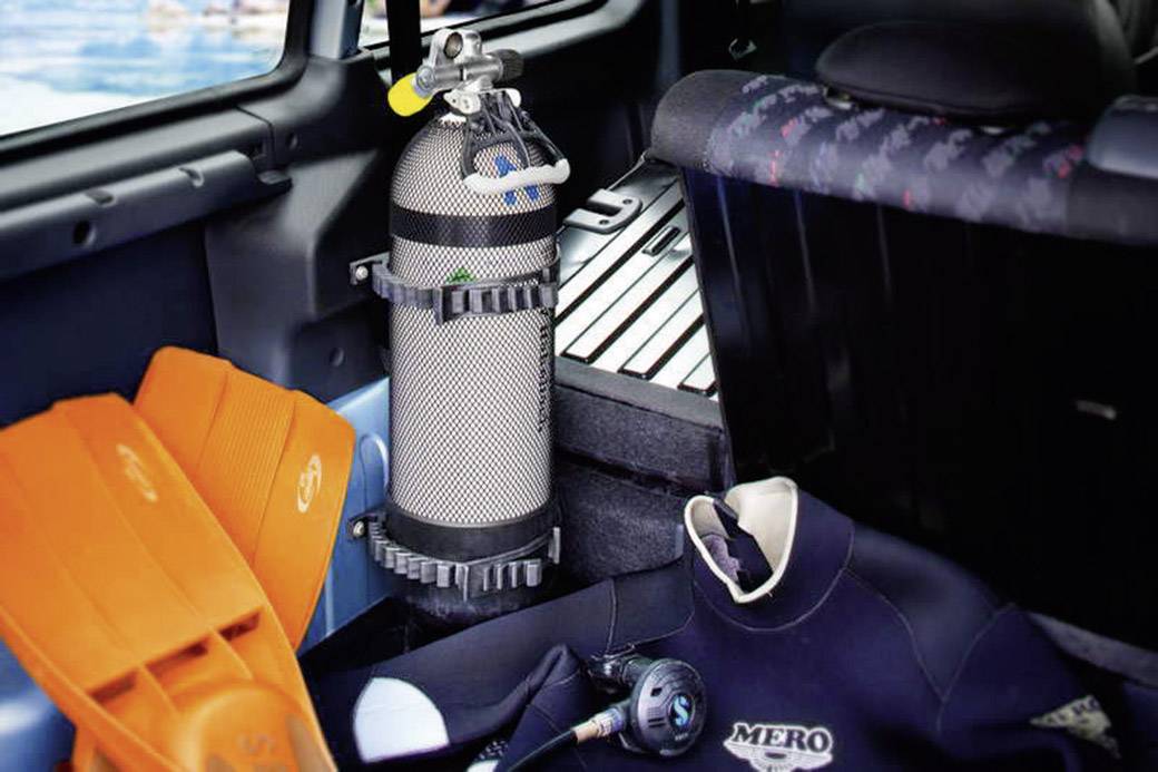 Diving Equipment in the Car: Diving Cylinder, Fins, Wetsuit and Regulator