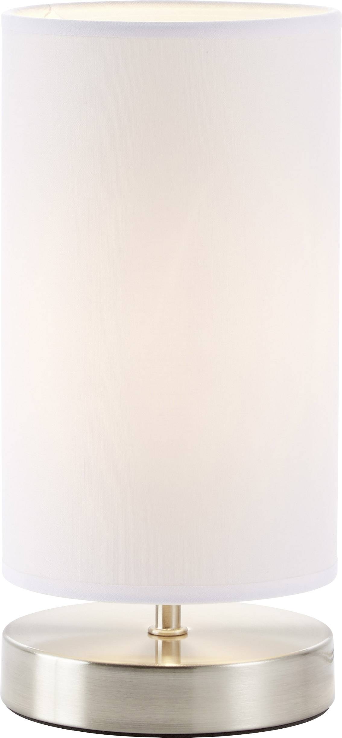 Table lamp with a cylindrical, white lampshade on a round, metallic base.