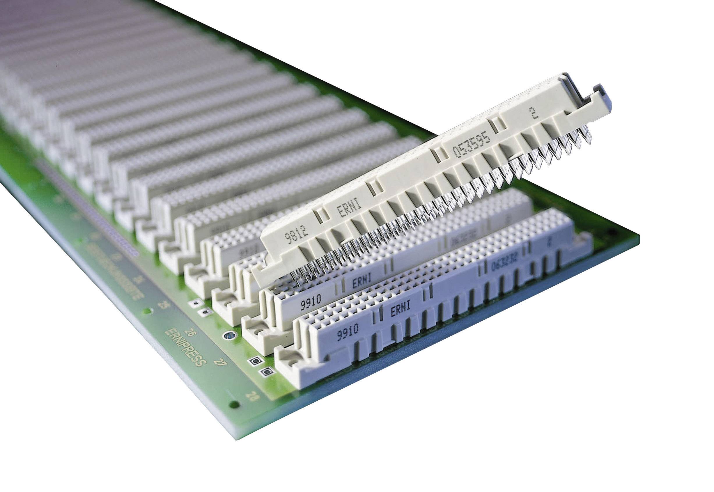 Close-up of white connectors on a green circuit board, used for electronic connections.