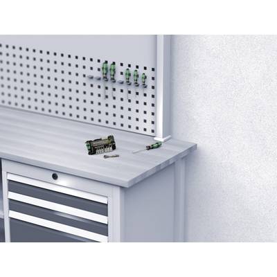 Workbench with screwdrivers and bit set on the surface, with some screwdrivers hanging on the wall-mounted rack above.