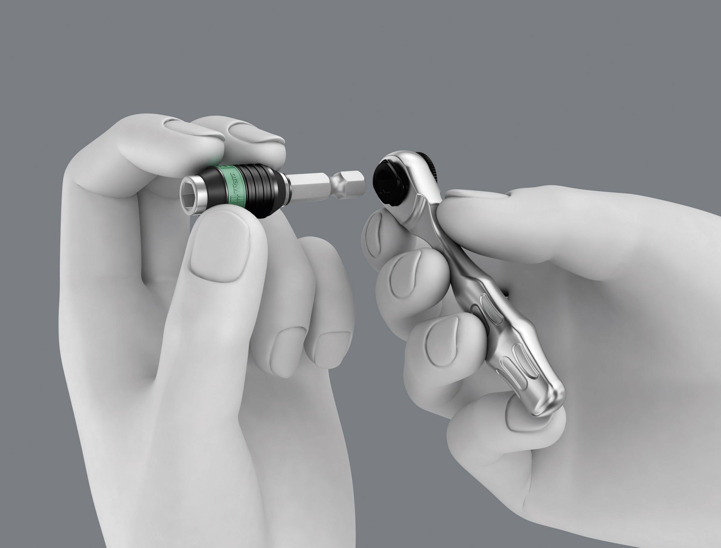 Two hands are holding a bit and a ratchet, ready to connect.