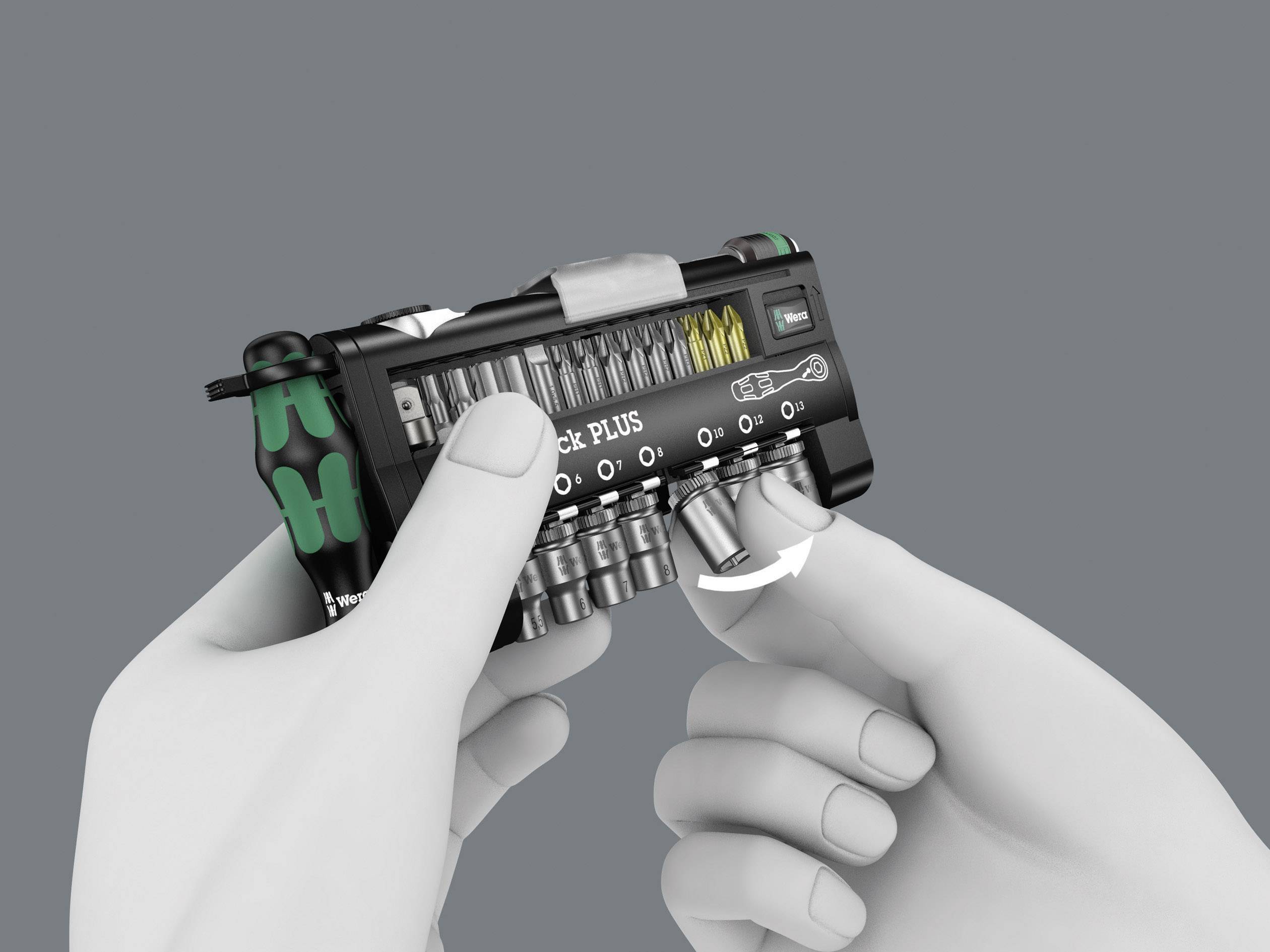 A toolbox is being held by two hands. Various bits and screwdriver attachments are visible.