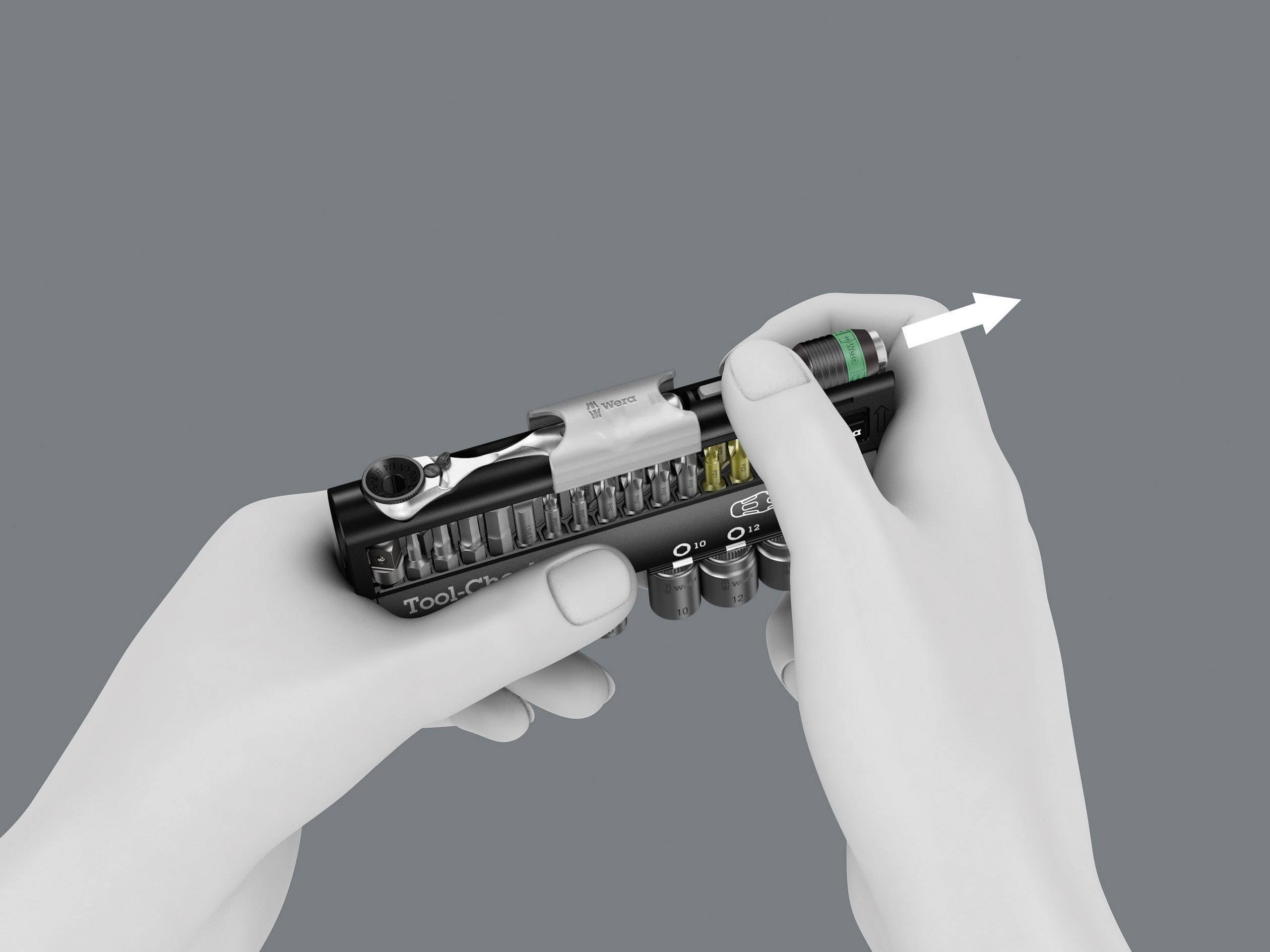 Hands are holding a compact tool set. An arrow points to a removable bit being pulled out from the set.