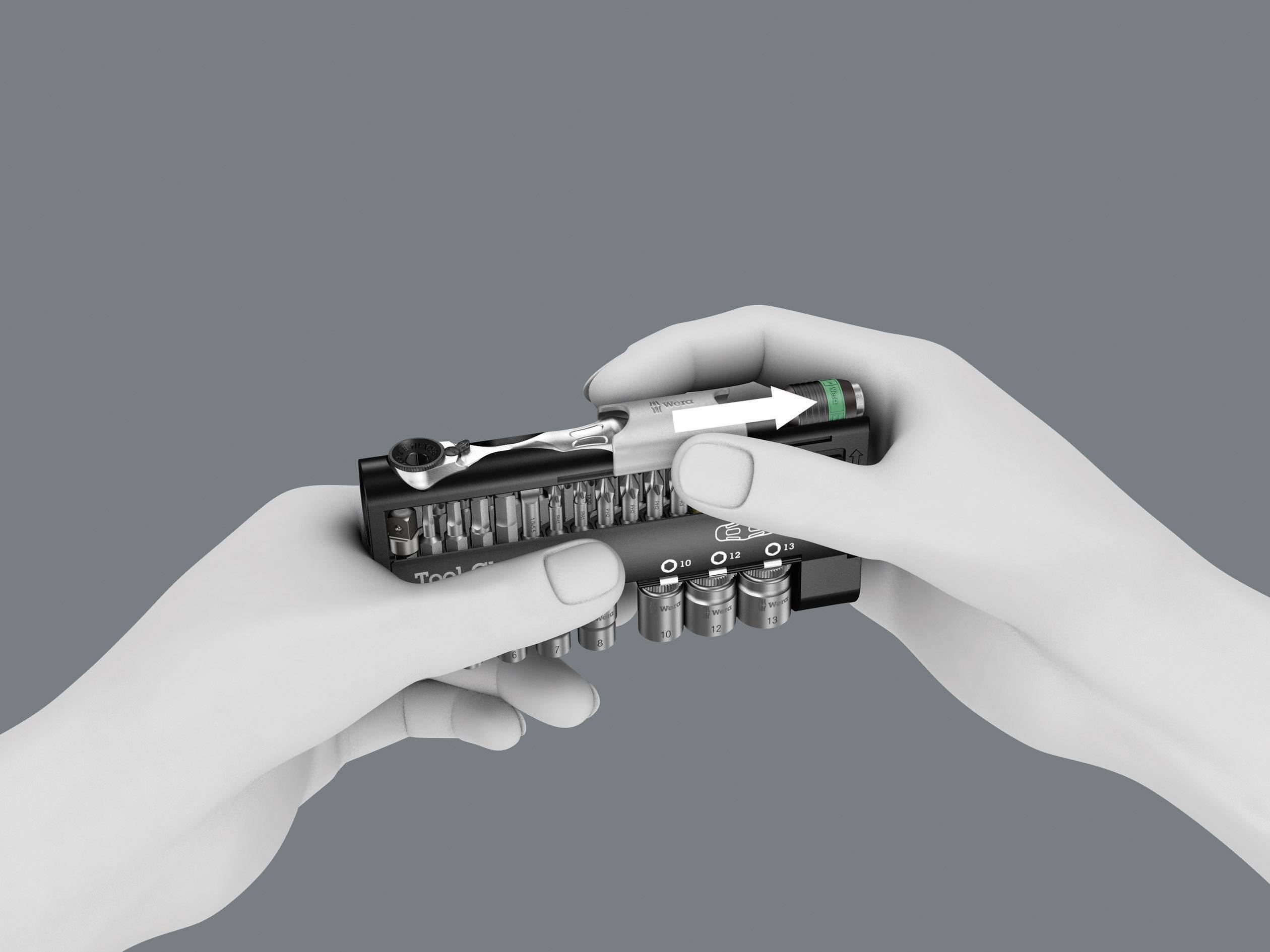 Two hands hold a bit set with various screwdriver bits and a screwdriver on a grey background.