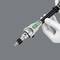 A hand holds a medical device, possibly a surgical tool with green and black elements, against a grey background.