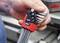 A hand is holding a set of hexagonal Allen keys in a red holder with the inscription 'wiha Ergostar'. Tools are visible in the background.