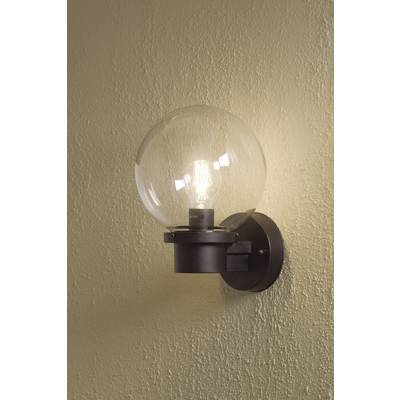 Wall light with a round, clear glass shade and visible light bulb, casting a soft yellow light against a beige background.