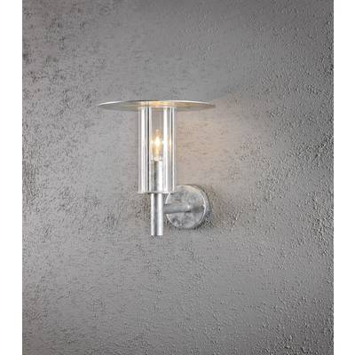 Modern silver wall light with glass cylinder, casting warm light against a grey, textured wall.