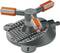 Grey lawn sprinkler with three adjustable arms and orange accents, suitable for uniform irrigation of garden areas.