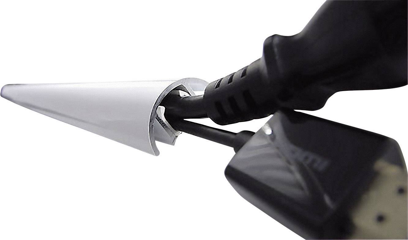 An HDMI cable is routed through a round, white cable grommet on a table, connecting electronic devices.