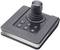 A black joystick with six numbered buttons (1-6) on a rectangular base. Primary control device for gaming or navigation.