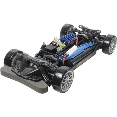 Model car chassis with visible electronics and wired components, mounted tyres, front suspension, and engine.