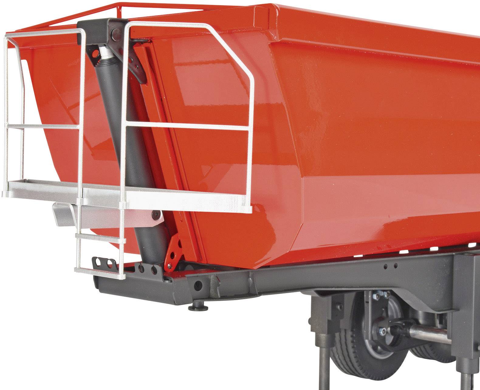 Red trailer with an open rear, mounted on a black chassis. Suspension and wheel components are visible.
