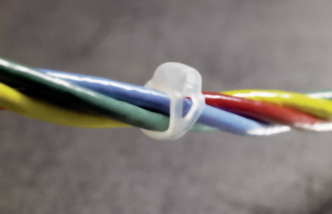 Close-up of a cable with multiple coloured cores, bundled together with a transparent clip. Background out of focus.
