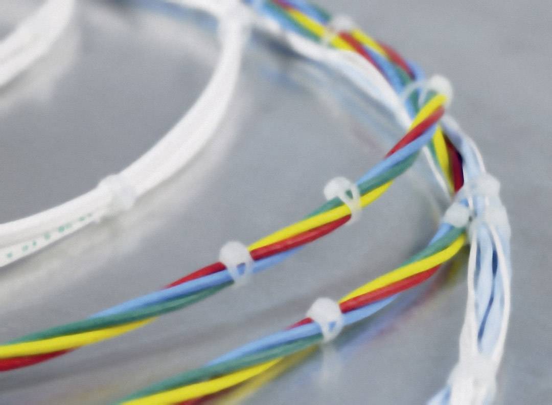 Colourful cable bundles with white cable ties on a grey surface.