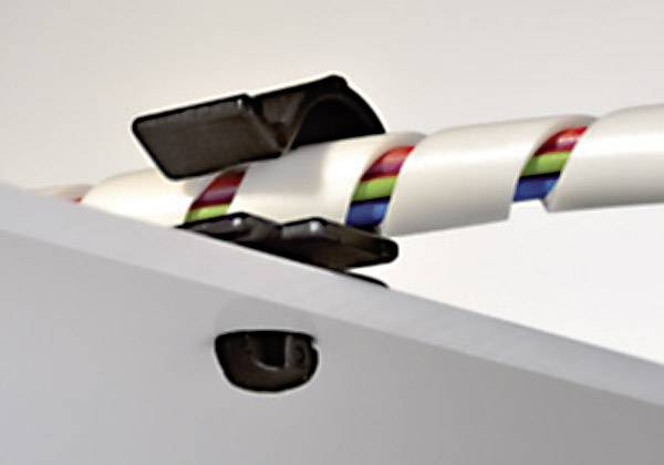 A cable with multiple colour codings is guided through a mount that ensures secure attachment to a flat surface.