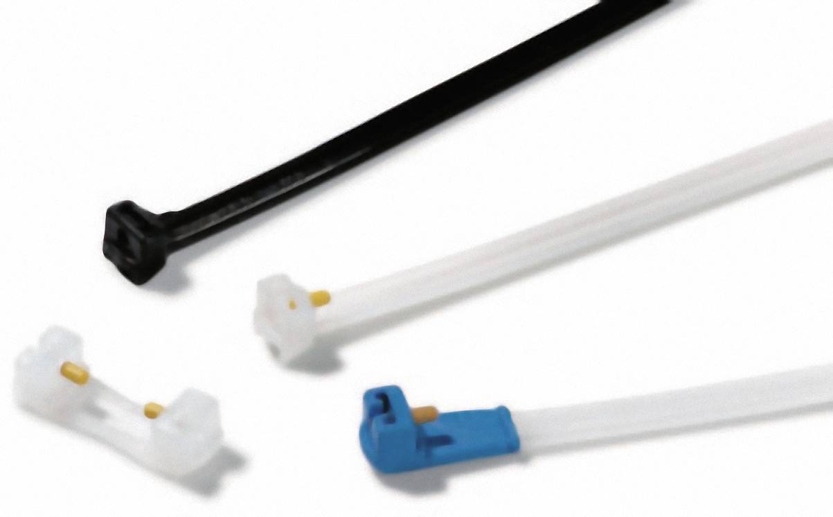 Several cable ties in different colours, including black, white and blue, are lying on a surface.