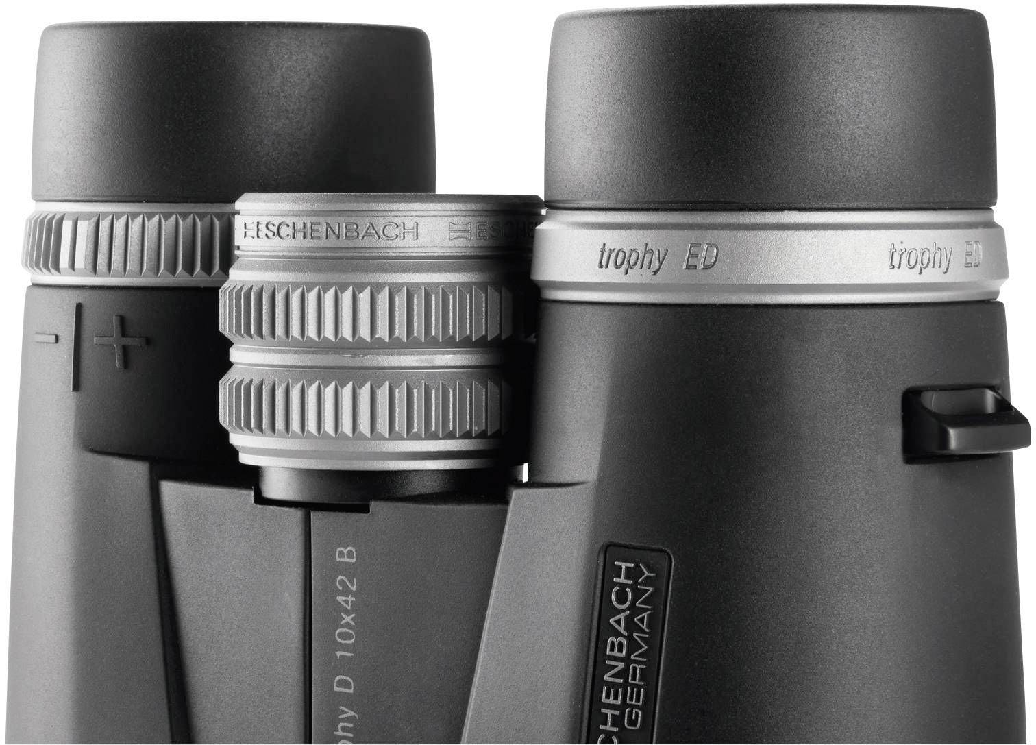 Binoculars with the inscription 'Eschenbach Germany'. 'Trophy ED' model identifiable. Focus ring in the centre, grey colour.