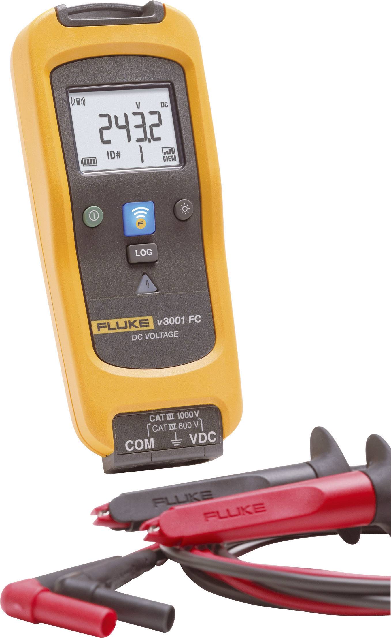 A yellow digital voltage metre displays '243.2 V'. It has buttons for recording and connecting with measuring leads underneath.