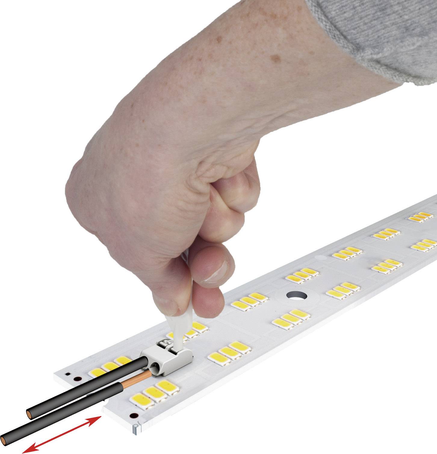 A hand connects an LED strip with cables by closing a connector. The LED strip contains yellow LED chips.