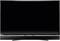 A black, switched-off flat-screen television sits on a table. The display is dark and the frame is silver-coloured.