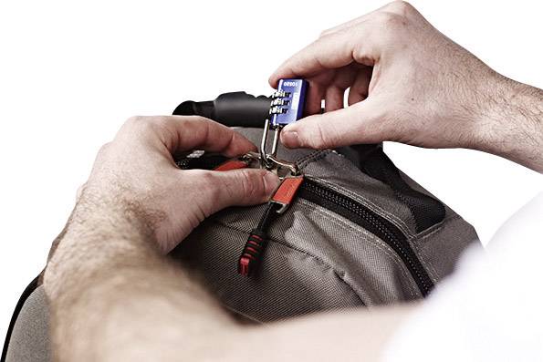 A person is securing a rucksack with a blue combination lock to ensure security.
