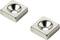 Two square metal plates with recessed round holes in the centre, on a white background.