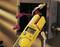 A yellow multimeter is measuring 15.8 amperes of alternating current at an open junction box with visible wires and connectors.