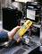 A person is measuring the electrical voltage of an air conditioning unit with a digital multimeter, which indicates 28 volts.