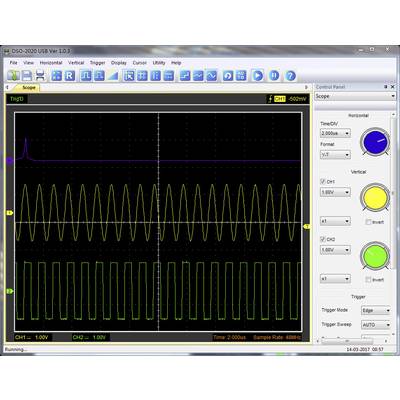 An oscilloscope displays two waveforms: a purple sine wave and a green square wave. The amplitudes and frequencies vary.