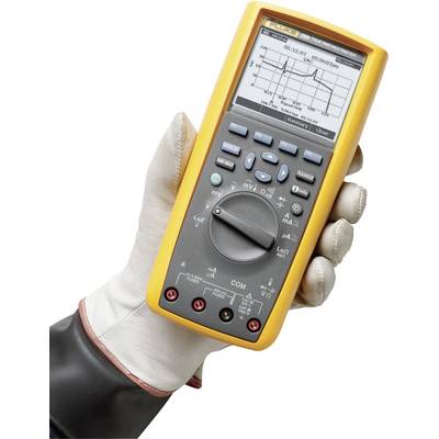 A gloved hand holds a digital multimeter displaying various electrical measurements on its screen.