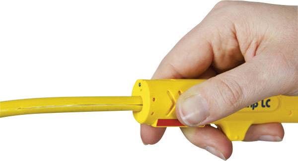 A hand is holding a yellow wire stripping tool, which is stripping a cable.